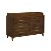 Malia 6-drawer dresser with changing topper in walnut, angled view showing brass colored pulls and tapered legs
