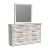 Avalanche dresser and mirror set in antique white, angled view showing eight paneled drawers with textured metal pulls