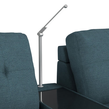 Adjustable reading light mounted on the media console between two teal seats