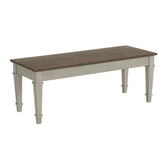 Farmington storage dining bench, medium brown top and washed stone base, angled side view