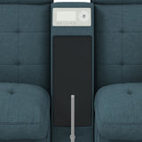 Top-down view of the media console between two tufted seat cushions with a control panel and black surface