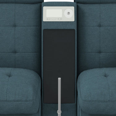 Top-down view of the media console between two tufted seat cushions with a control panel and black surface