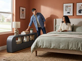 Valari Side Bookcase in grey PU against a terracotta bedroom wall, holding books, a lamp and a plant