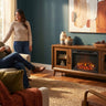 Elements International Santa Barbara - 60" TV Console in Walnut w/23" Fireplace Insert styled in a designer-styled interior lifestyle setting at Quality Home Furniture
